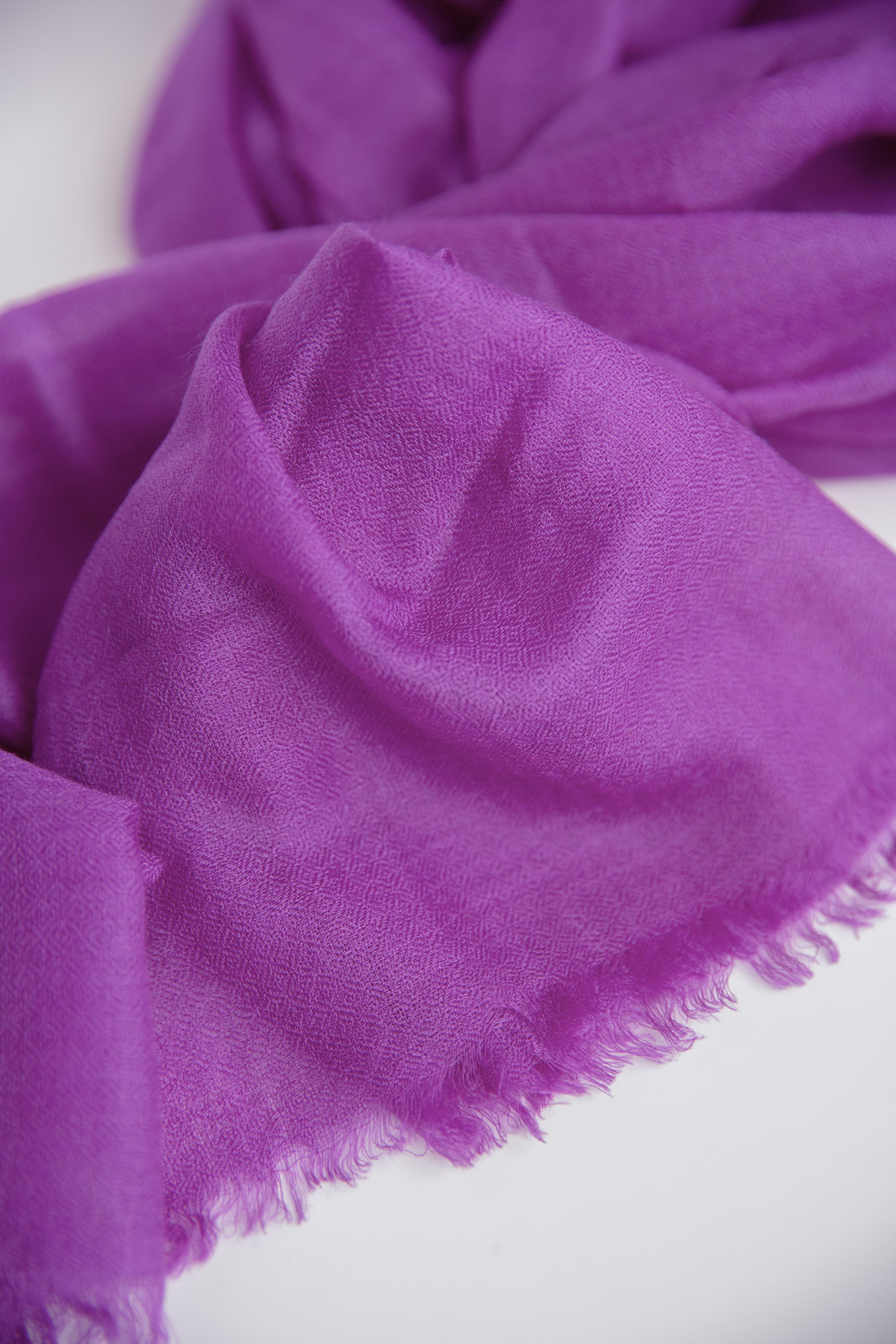 Close-up of a purple scarf with a white background