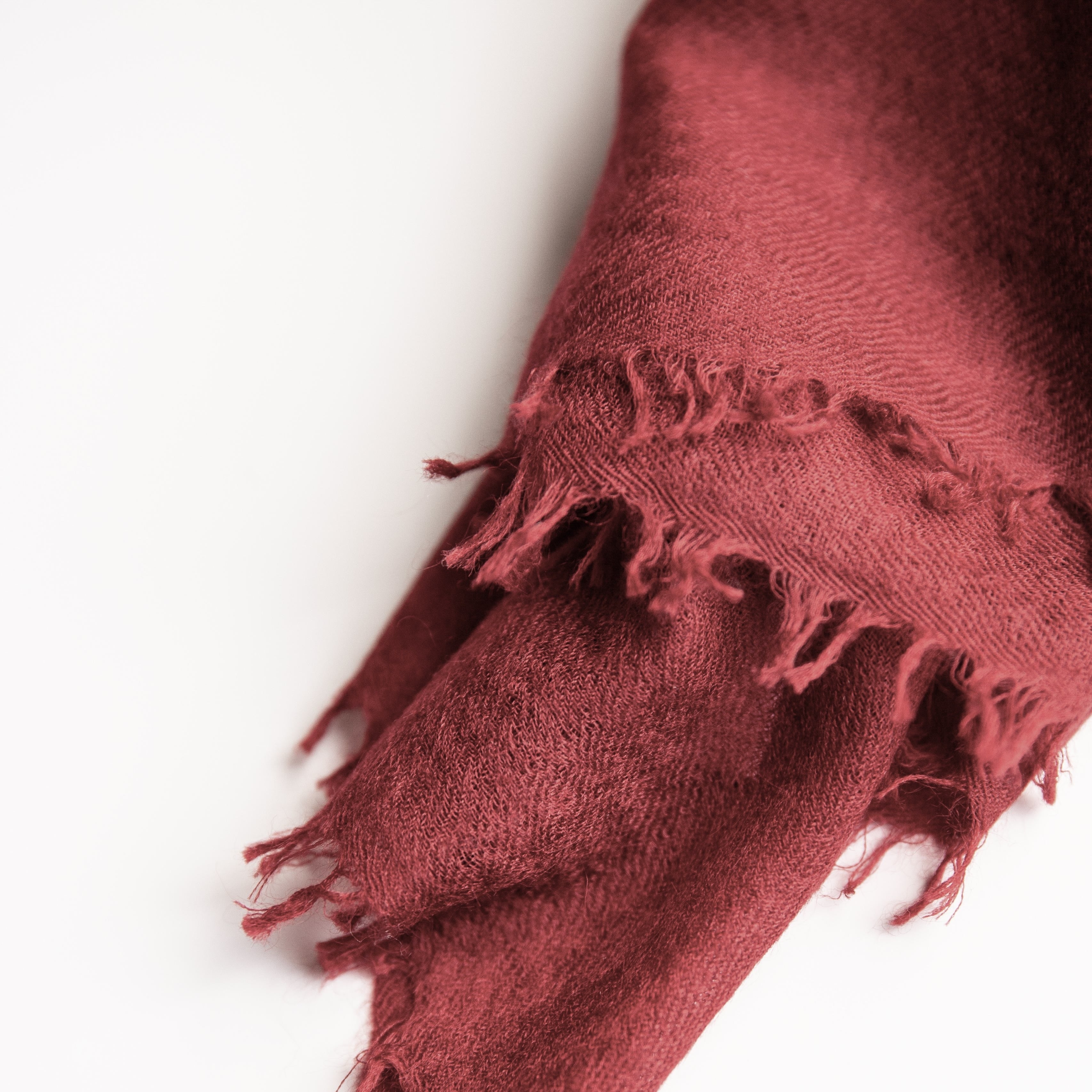 Red scarf with fringes on a white background