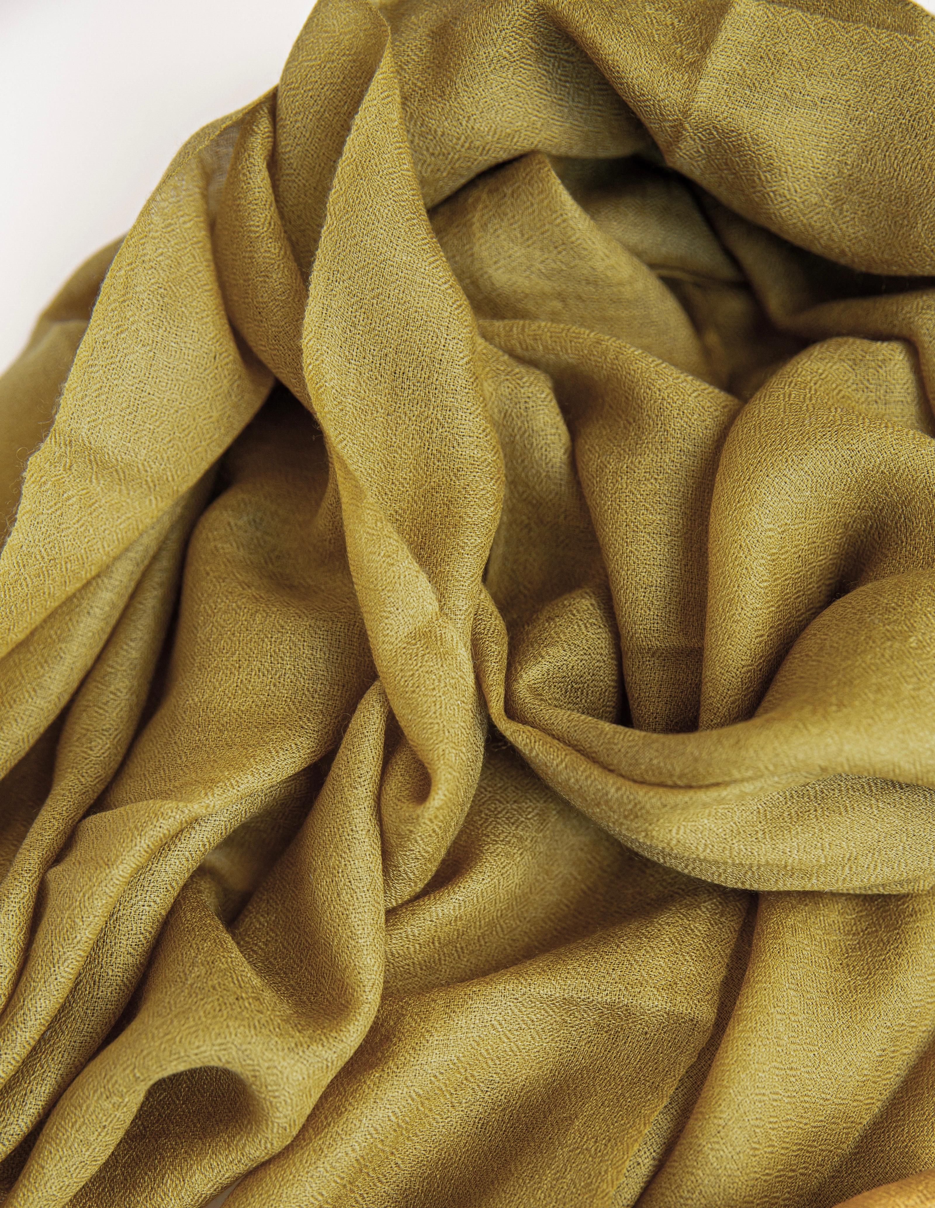 Close-up of olive green fabric with a soft texture